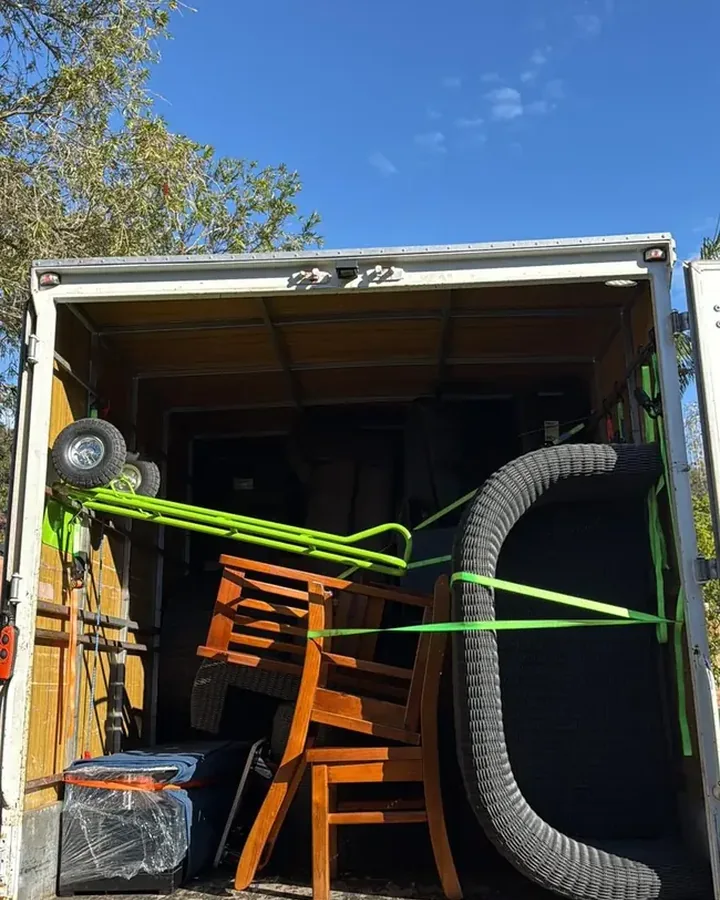 Furniture secured with moving blankets and straps inside a Move Mate Movers truck