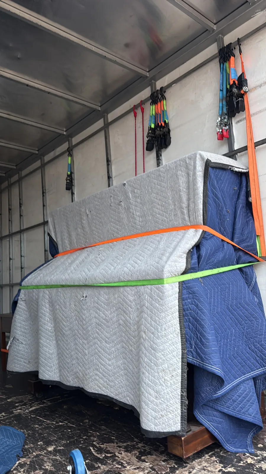 Furniture protected with moving blankets and secured inside the truck
